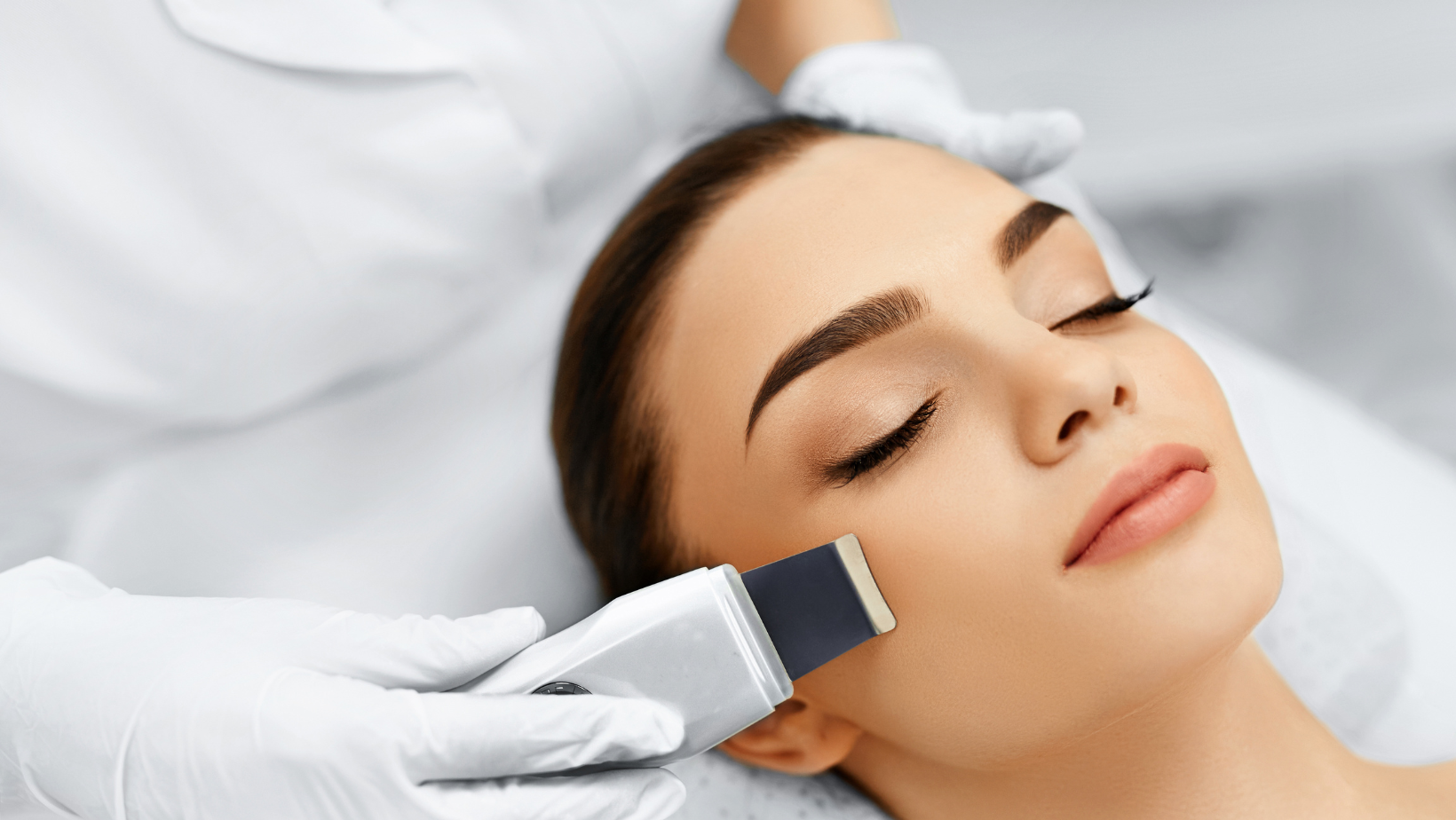 A beautiful girl receiving an ultrasound facial from an experienced Esthetician.