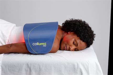 Celluma LED panel on the back for pain management from an experienced Esthetician